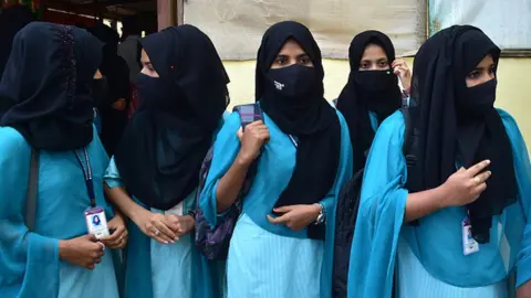 Getty Images Indian Muslim Students leave after they were not allowed to enter the Pre-university colleges while wearing Hijab, in Udupi town in the southern state of Karnataka India on February 16, 2022