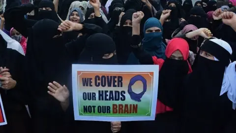 Getty Images Muslim Womens from Thane Mumbra on sunday staged an agitation against the Karnataka government and organized a rally in support of the hijab in protest of the ban on hijab by Muslim students in colleges in the state of Karnataka ,in Thane, on February 13, 2022 i