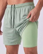 Real Essentials 3 Pack: Men's 2 in 1 Mesh 7" Running Workout Gym Shorts with Compression Liner (Available in Big & Tall) - Image 4
