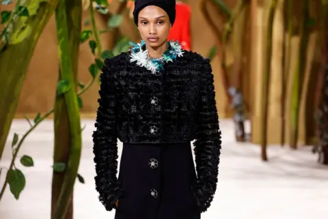 GEOFFROY VAN DER HASSELT / AFP via Getty Images Somali-US model Ugbad Abdi presents a creation for Chanel for the Women Haute Couture Fall/Winter 2026-2027 collection as part of the Paris Fashion Week, in Paris, on July 7, 2026.