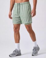 Real Essentials 3 Pack: Men's 2 in 1 Mesh 7" Running Workout Gym Shorts with Compression Liner (Available in Big & Tall) - Image 2