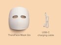 A product image of the TheraFace Mask Glo-LED Skincare Mask, a white plastic mask that emits red light on the interior.
