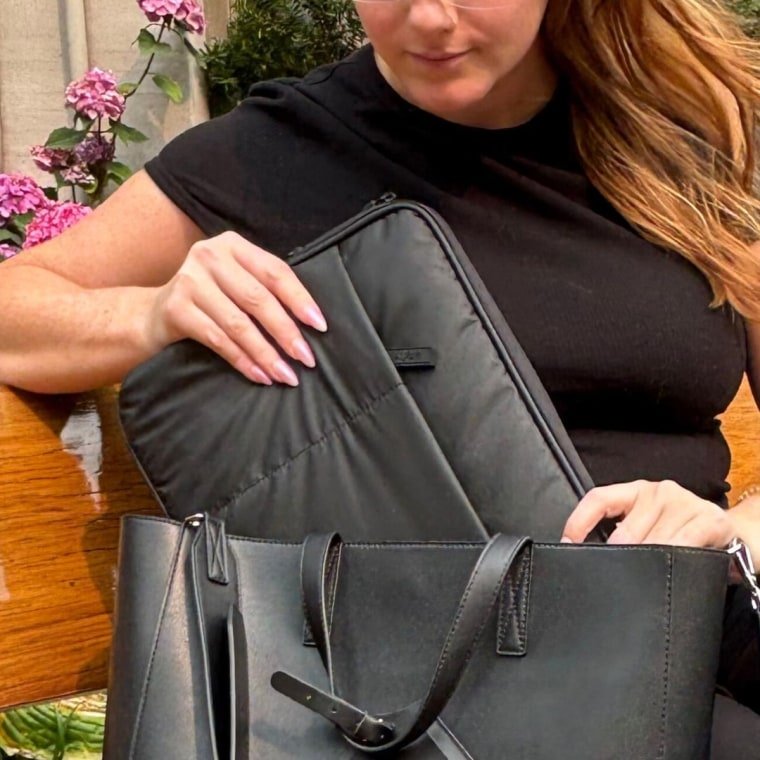 Woman sitting with Luka Padded Laptop Sleeve sitting next to her in the Luka Haven Tote.