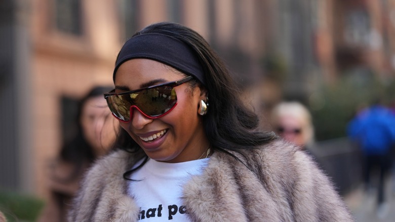 A woman wearing a headband and sunglasses