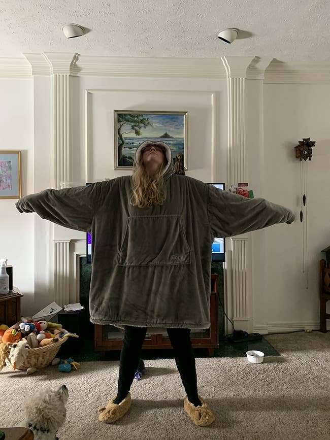 A reviewer in the grey sweatshirt, which goes down to their knees