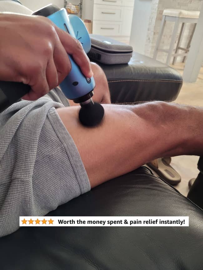 A reviewer using the round attachment on their thigh with five star review text