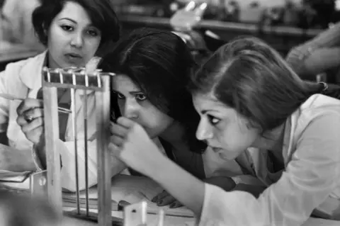 A. Abbas / Magnum Photos Female students perform a test in the chemistry lab of Tehran University in 1977