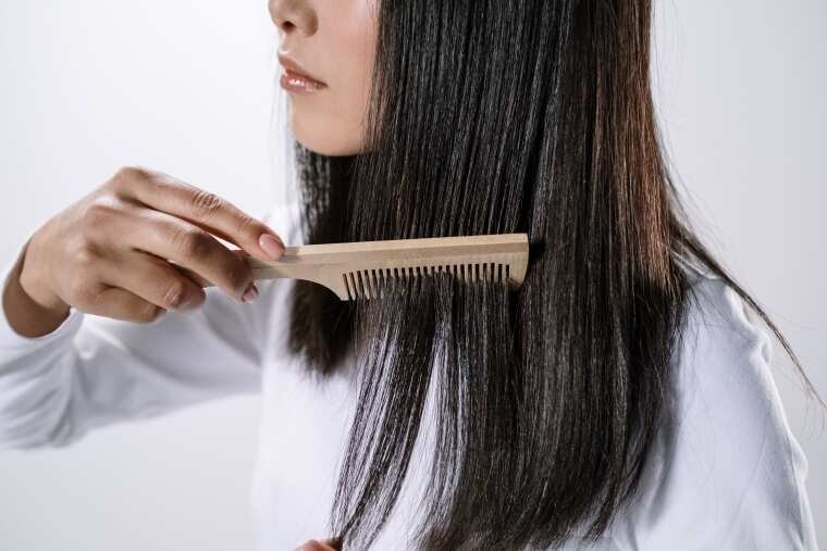 A woman combing her hair.