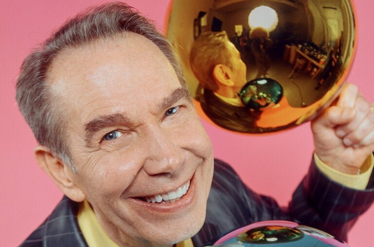 The artist Jeff Koons, photographed with two of his handblown gazing balls at his studio in Hell’s Kitchen on June 9, 2026, wears an Hermès jacket, hermes.com; and Bottega Veneta shirt, bottegaveneta.com.