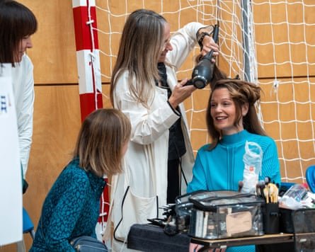 Victoria Starmer having her hair blow dried while chatting to someone in a school sports hall