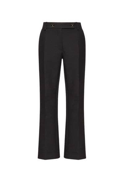 Black tailored pants with belt and buckles, displayed on a white background.